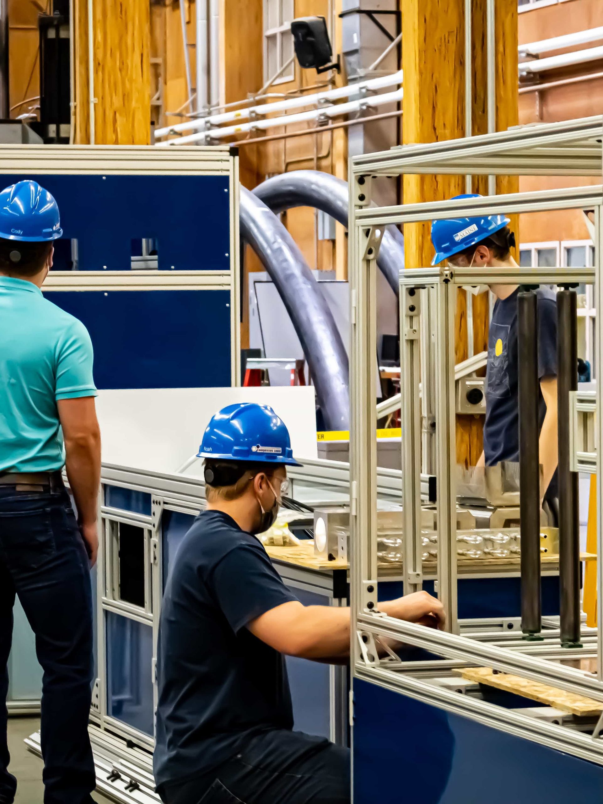 Students in hard hats working on the CFM machine